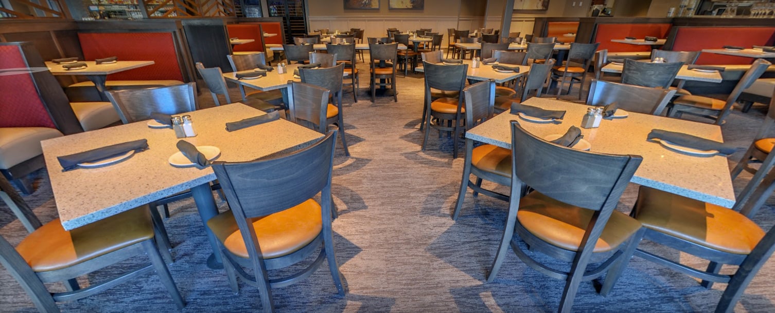 Peachtree-Corners-GA-aerial-view-of-restaurant-interior-dining-room-with-rows-of-tables-centered-around-chairs-with-rows-of-booths-and-tables-along-each-side