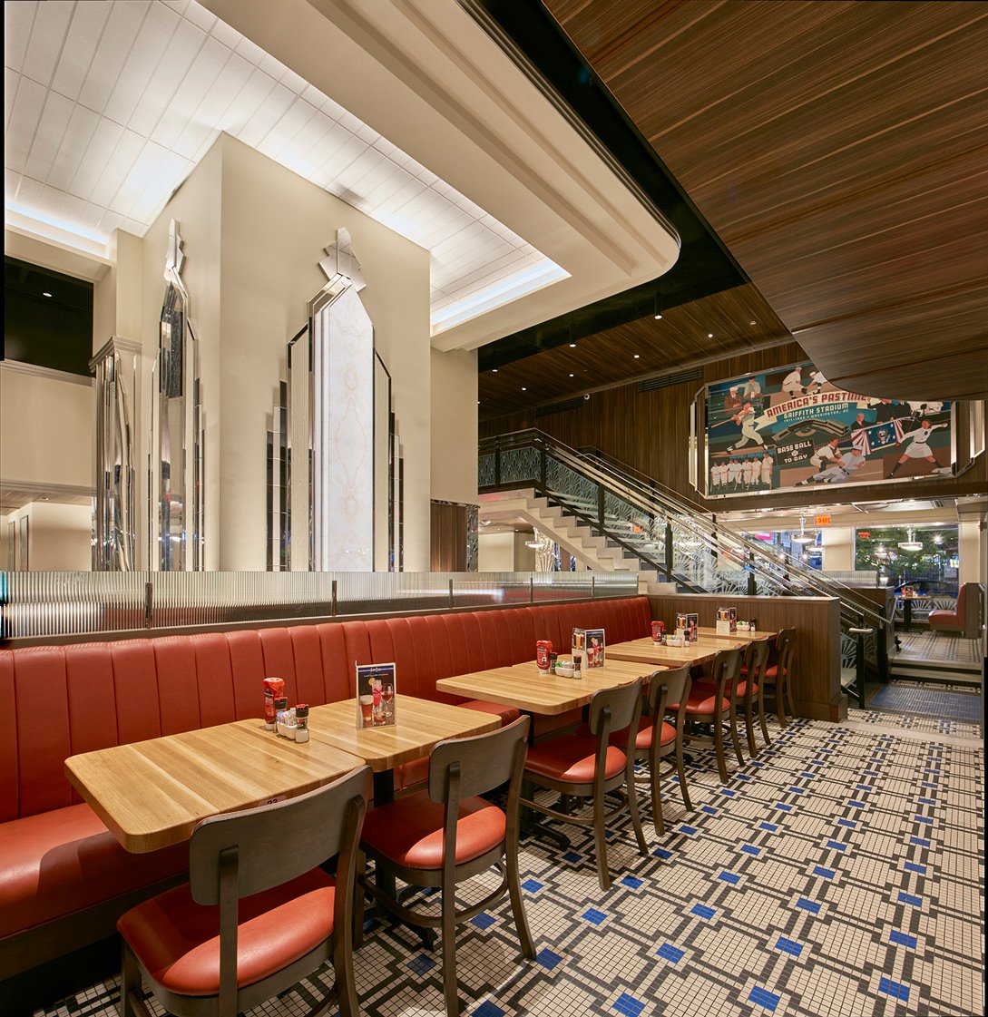 Washington-DC-aerial-view-of-restaurant-interior-with-elongated-red-leather-booth-lined-with-tables-and-facing-chairs